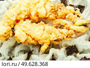 Fried sea bass fish with rice on rice paper.. Appetizing fried sea bass fish, seafood. Стоковое фото, агентство Ingram Publishing / Фотобанк Лори