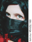 Young woman wearing a black face mask. Стоковое фото, агентство Ingram Publishing / Фотобанк Лори