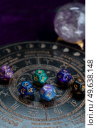 Horoscope zodiac circle with divination dice. Fortune telling and astrology predictions concept, magic rituals and exoteric experience. Zodiac horoscope with divination dice. Стоковое фото, агентство Ingram Publishing / Фотобанк Лори