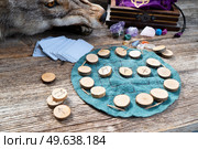 Handmade runes for fortunetelling over leather chart. Handmade runes for fortunetelling. Стоковое фото, агентство Ingram Publishing / Фотобанк Лори