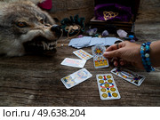 Fortune telling on tarot cards, witch hand is opening cards, used Marseille Tarot deck by unknown artist published first in 1709. Fortune telling on tarot cards. Стоковое фото, агентство Ingram Publishing / Фотобанк Лори