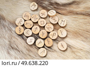 Handmade runes for fortunetelling of wood over wolf fur. Handmade runes for fortunetelling. Стоковое фото, агентство Ingram Publishing / Фотобанк Лори
