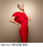 Fashion portrait of elegant woman with magnificent hair. Blonde girl. Perfect make-up. Girl in elegant red dress. Girl posing. Studio photo. Стоковое фото, агентство Ingram Publishing / Фотобанк Лори