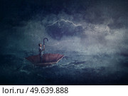 Sailing painting with a lone person in the ocean floating on an umbrella boat. Surreal scene with a storm over the sea. Fantastic adventure, conquering and facing adversity concept. Стоковое фото, агентство Ingram Publishing / Фотобанк Лори