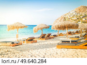 summer beach with sunbeds, Mykonos island, Greece with sunshine. Mykonos island, Greece. Стоковое фото, агентство Ingram Publishing / Фотобанк Лори