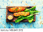 Tasty chicken breast skewers and peanut sauce. Chicken satay. Chicken shashlik with peanut sauce. Стоковое фото, агентство Ingram Publishing / Фотобанк Лори