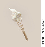 Whipped cream at flying wooden whisker at pale beige background. Levitation food concept with baking utensils. Front view. Стоковое фото, агентство Ingram Publishing / Фотобанк Лори