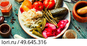 Assorted of pickles from tomato, sauerkraut, okra, cucumbers and cowpea. Pickles and marinated vegetables. Assorted homemade pickles. Стоковое фото, агентство Ingram Publishing / Фотобанк Лори