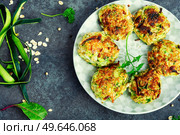 Vegan cutlets from zucchini, oatmeal and greens. Healthy food, vegetable cutlet. Vegan zucchini cutlets or fritter. Стоковое фото, агентство Ingram Publishing / Фотобанк Лори