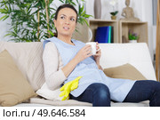 house keeper having a rest on the sofa. Стоковое фото, агентство Ingram Publishing / Фотобанк Лори