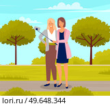 Two girlfriends take selfie on phone while walking in park. Friendship, photo in garden. Friends take pictures during meeting outdoor on weekend. Women use smartphone to record post for social network. Two girlfriends take selfie on phone while walking in sity park. Friendship, photo in garden. Стоковая иллюстрация, агентство Ingram Publishing / Фотобанк Лори