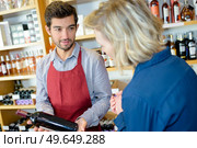 wine seller making recommendation to customer. Стоковое фото, агентство Ingram Publishing / Фотобанк Лори
