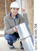 woman holding steel metal on site. Стоковое фото, агентство Ingram Publishing / Фотобанк Лори