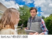 Lady showing tablet screen to worker. Стоковое фото, агентство Ingram Publishing / Фотобанк Лори