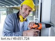 worker man drilling in concrete on a construction site. Стоковое фото, агентство Ingram Publishing / Фотобанк Лори