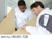 young professional construction workers plastering. Стоковое фото, агентство Ingram Publishing / Фотобанк Лори