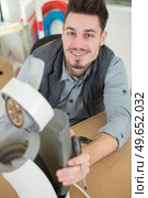 serious man repairing broken coffee machine. Стоковое фото, агентство Ingram Publishing / Фотобанк Лори