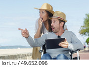 couple in wheelchair looking surprised at women. Стоковое фото, агентство Ingram Publishing / Фотобанк Лори