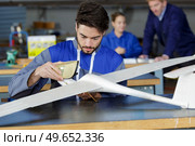 young man working on model glider. Стоковое фото, агентство Ingram Publishing / Фотобанк Лори