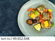 Baked hake fish on the plate. White fish with orange and mushrooms. Seafood. Fried dietary sea fish hake. Стоковое фото, агентство Ingram Publishing / Фотобанк Лори