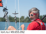 Bedraggled man in sailing vessel. Стоковое фото, агентство Ingram Publishing / Фотобанк Лори