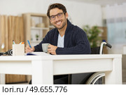 smiling young man in wheelchair. Стоковое фото, агентство Ingram Publishing / Фотобанк Лори