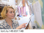 smiling blonde female engineer checking planing. Стоковое фото, агентство Ingram Publishing / Фотобанк Лори
