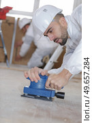a man polishing the floor. Стоковое фото, агентство Ingram Publishing / Фотобанк Лори