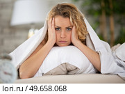 worried young woman laying in bed sleepless at night. Стоковое фото, агентство Ingram Publishing / Фотобанк Лори