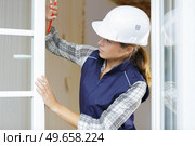 female worker by open pvc windows. Стоковое фото, агентство Ingram Publishing / Фотобанк Лори