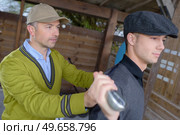a man training young golfer. Стоковое фото, агентство Ingram Publishing / Фотобанк Лори