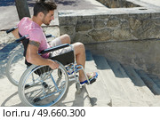 young man in a wheelchair cannot descend steps. Стоковое фото, агентство Ingram Publishing / Фотобанк Лори