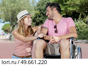 man in wheelchair and his wife enjoying in the park. Стоковое фото, агентство Ingram Publishing / Фотобанк Лори