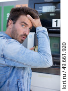 shocked man counting money with gasoline refueling car. Стоковое фото, агентство Ingram Publishing / Фотобанк Лори