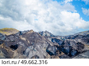 Icy glacier mountains covered in dirt with blue ice underneath. Стоковое фото, агентство Ingram Publishing / Фотобанк Лори