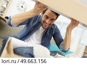 excited man opening his box. Стоковое фото, агентство Ingram Publishing / Фотобанк Лори