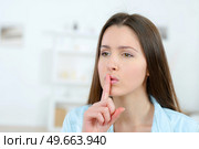Woman gesturing us to be quiet. Стоковое фото, агентство Ingram Publishing / Фотобанк Лори