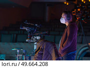 masked cameraman is filming a television show in the studio. TV. Стоковое фото, агентство Ingram Publishing / Фотобанк Лори
