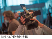 masked cameraman is filming a television show in the studio. TV. Стоковое фото, агентство Ingram Publishing / Фотобанк Лори