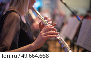 girl playing the flute at a concert. Стоковое фото, агентство Ingram Publishing / Фотобанк Лори