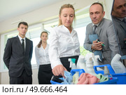trainee cleaning showing cleaning product to manager. Стоковое фото, агентство Ingram Publishing / Фотобанк Лори