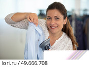 young woman ironing clothes on ironing board. Стоковое фото, агентство Ingram Publishing / Фотобанк Лори