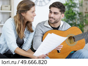 learning to play the guitar. Стоковое фото, агентство Ingram Publishing / Фотобанк Лори