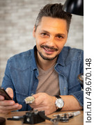 clockmaker repairing wrist watch at workshop. Стоковое фото, агентство Ingram Publishing / Фотобанк Лори