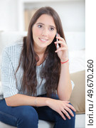 Young woman sitting and phoning. Стоковое фото, агентство Ingram Publishing / Фотобанк Лори