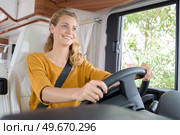 young woman driving a campervan. Стоковое фото, агентство Ingram Publishing / Фотобанк Лори