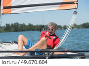 man sailing and dreams on river at summer day. Стоковое фото, агентство Ingram Publishing / Фотобанк Лори