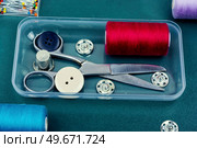 Home sewing kit, old scissors, needles, buttons Needlework concept. Various sewing tools, sewing items. Стоковое фото, агентство Ingram Publishing / Фотобанк Лори
