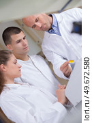 young male scientist with colleague and teacher. Стоковое фото, агентство Ingram Publishing / Фотобанк Лори