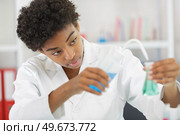 doctor or student compares two liquids in lab. Стоковое фото, агентство Ingram Publishing / Фотобанк Лори